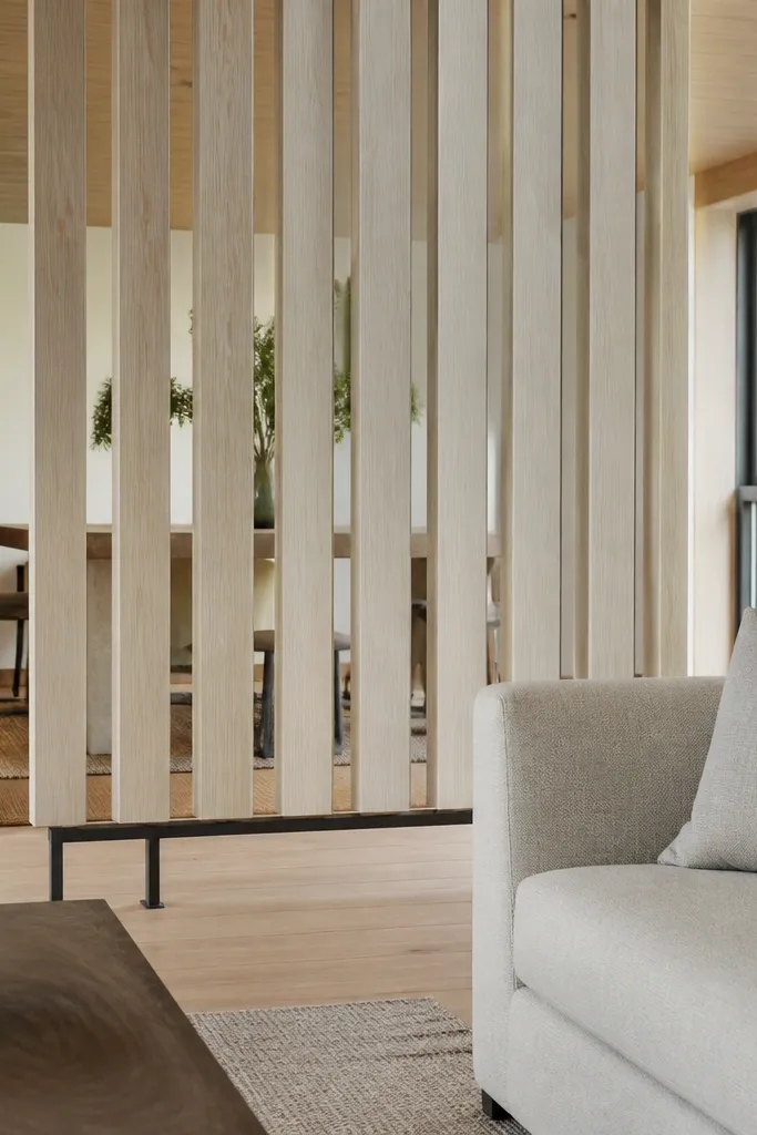 White slatted panel divider with legs in a small living room