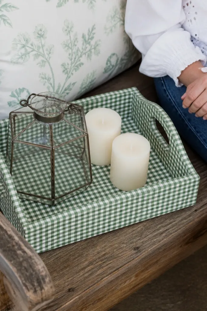 A lantern tray with green-and-white gingham accents and eggshell candles