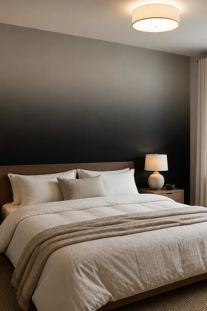 Black-to-gray ombre accent wall behind a bed fading upward